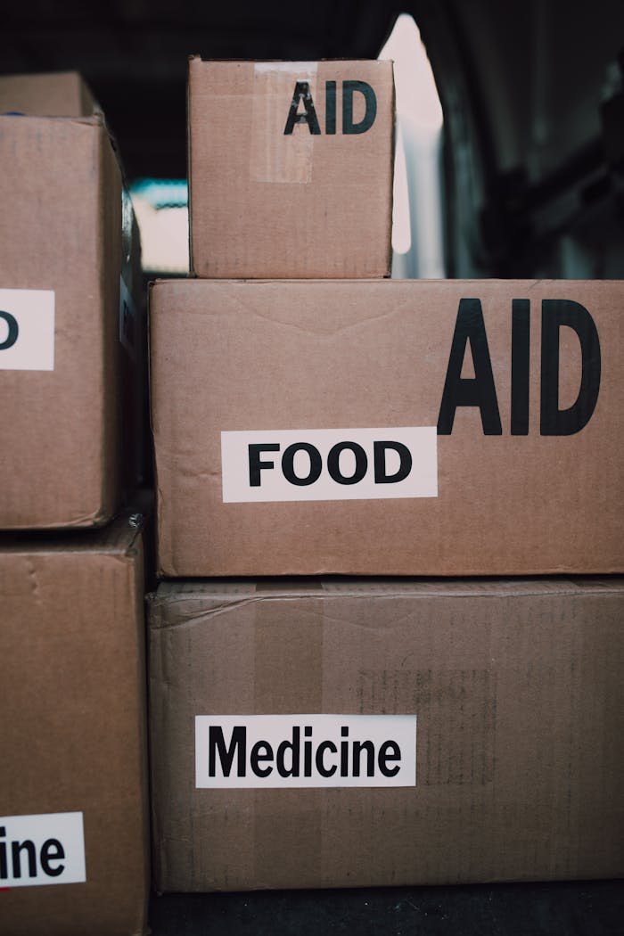 The Art of Drawing Readers In: Your attractive post title goes here Close-up of aid packages with labels for food and medicine, symbolizing charity and support.