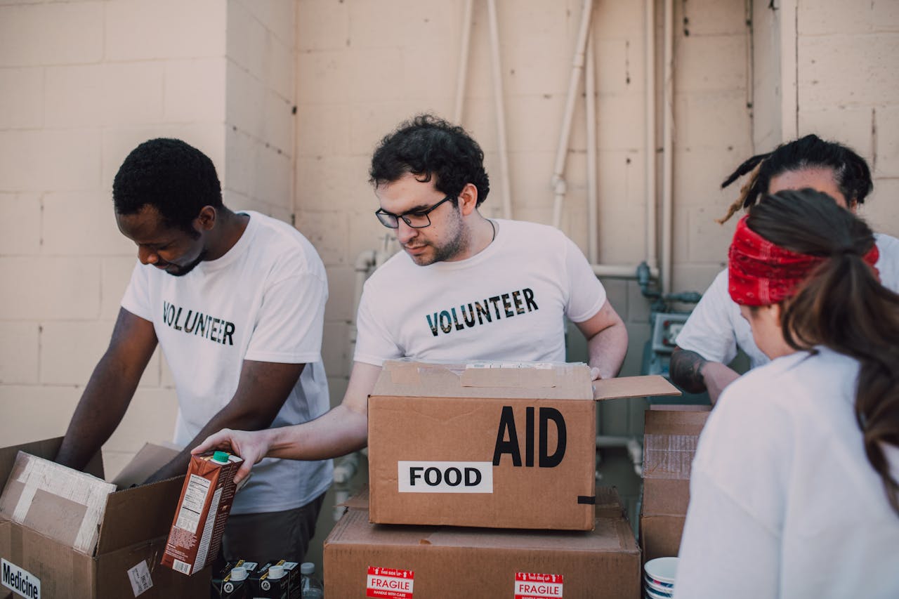 Crafting Captivating Headlines: Your awesome post title goes here Group of volunteers packing food and aid boxes during a charity drive.